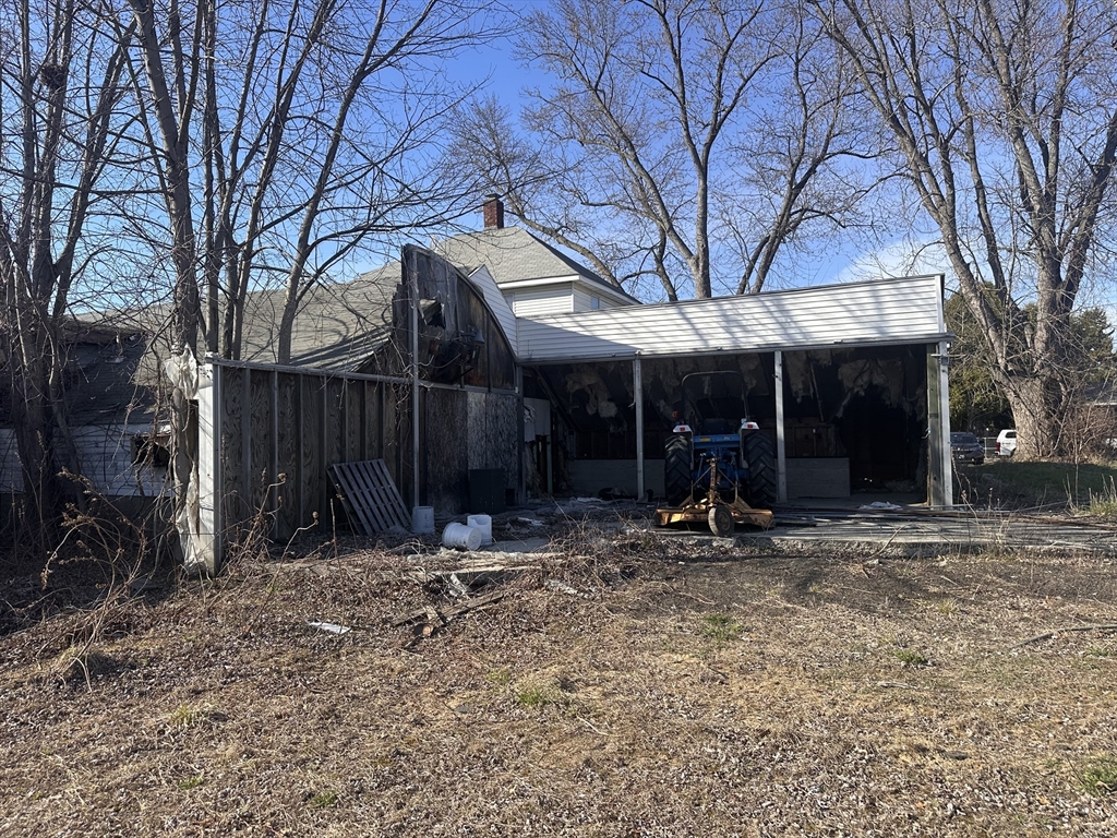 445 Chicopee Street Chicopee, MA 01013 - Photo 3 of 14 a view of a chairs and table in a backyard