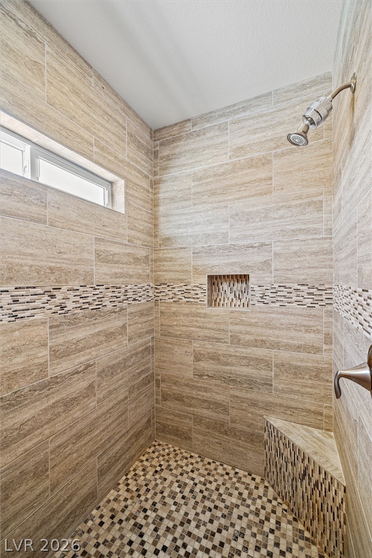 6720 Stubblefield Drive Pahrump, NV 89061 - Photo 31 of 51 A well-appointed shower space features elegant tile work and a convenient integrated bench.