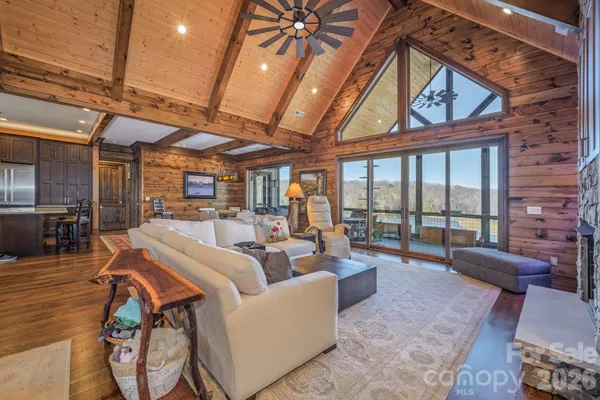 a kitchen with a table chairs refrigerator and microwave
