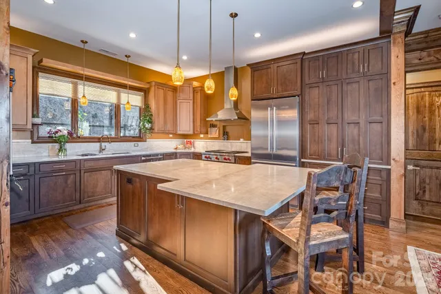 a kitchen with counter top space and wooden floor
