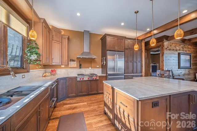 a outdoor space with lots of tables a large window and chairs