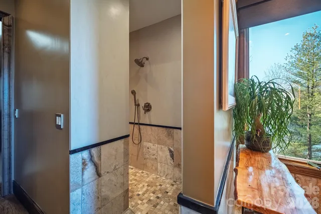 a living room with furniture and a floor to ceiling window