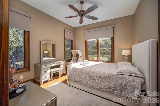 a spacious bathroom with a granite countertop sink a mirror and a bathtub