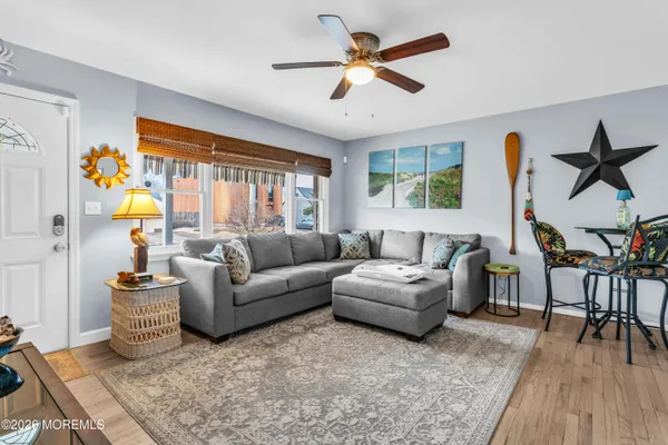 a living room with furniture a dining table and a large window