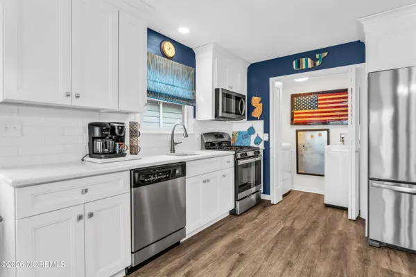 a kitchen with stainless steel appliances granite countertop a refrigerator and a stove top oven