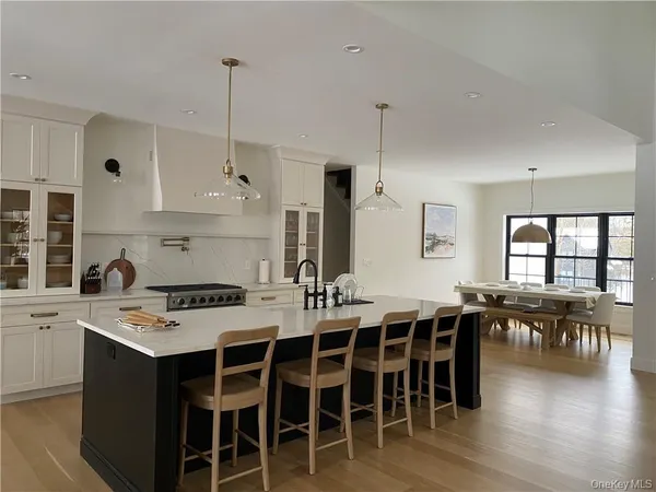 a large kitchen with a table and chairs