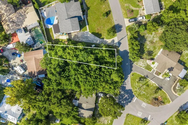 an aerial view of a house with a yard