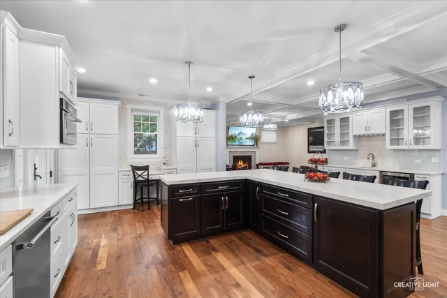 a large kitchen with stainless steel appliances granite countertop a stove and cabinets