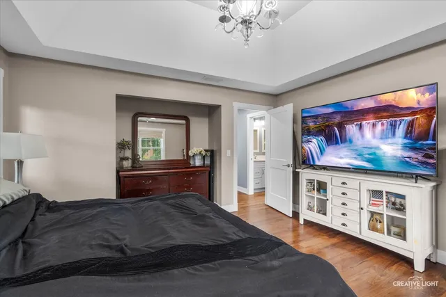 a bedroom with furniture and a chandelier