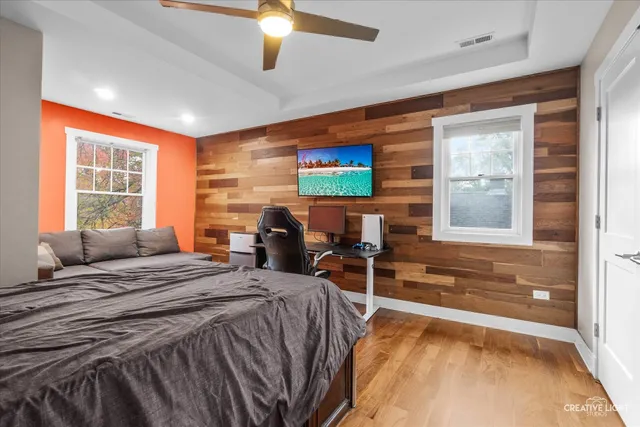 a bedroom with a bed and glass windows