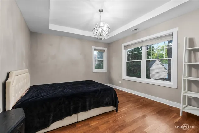 a bedroom with a bed dresser and a window