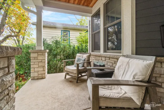 a balcony with furniture and a potted plant