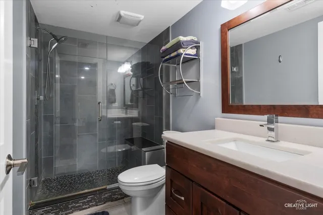 a bathroom with a sink toilet and shower