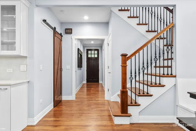 a view of an entryway with wooden floor and stairs