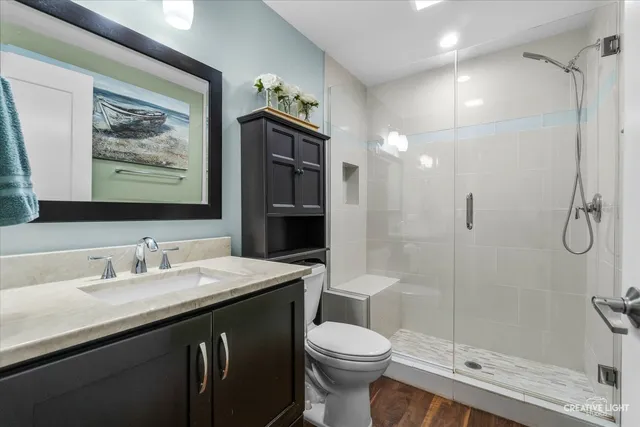 a bathroom with a sink toilet and shower