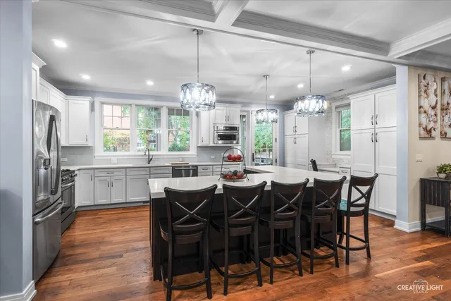 a large kitchen with a table and chairs