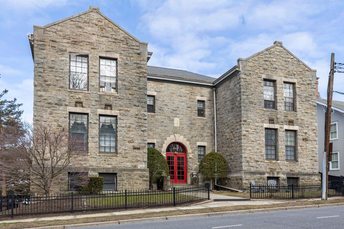 CENTRAL RYE LOCATION! View of front of home on Boston Post Road with beautiful stone siding and a fenced front yard. Walk to EVERYTHING in town!