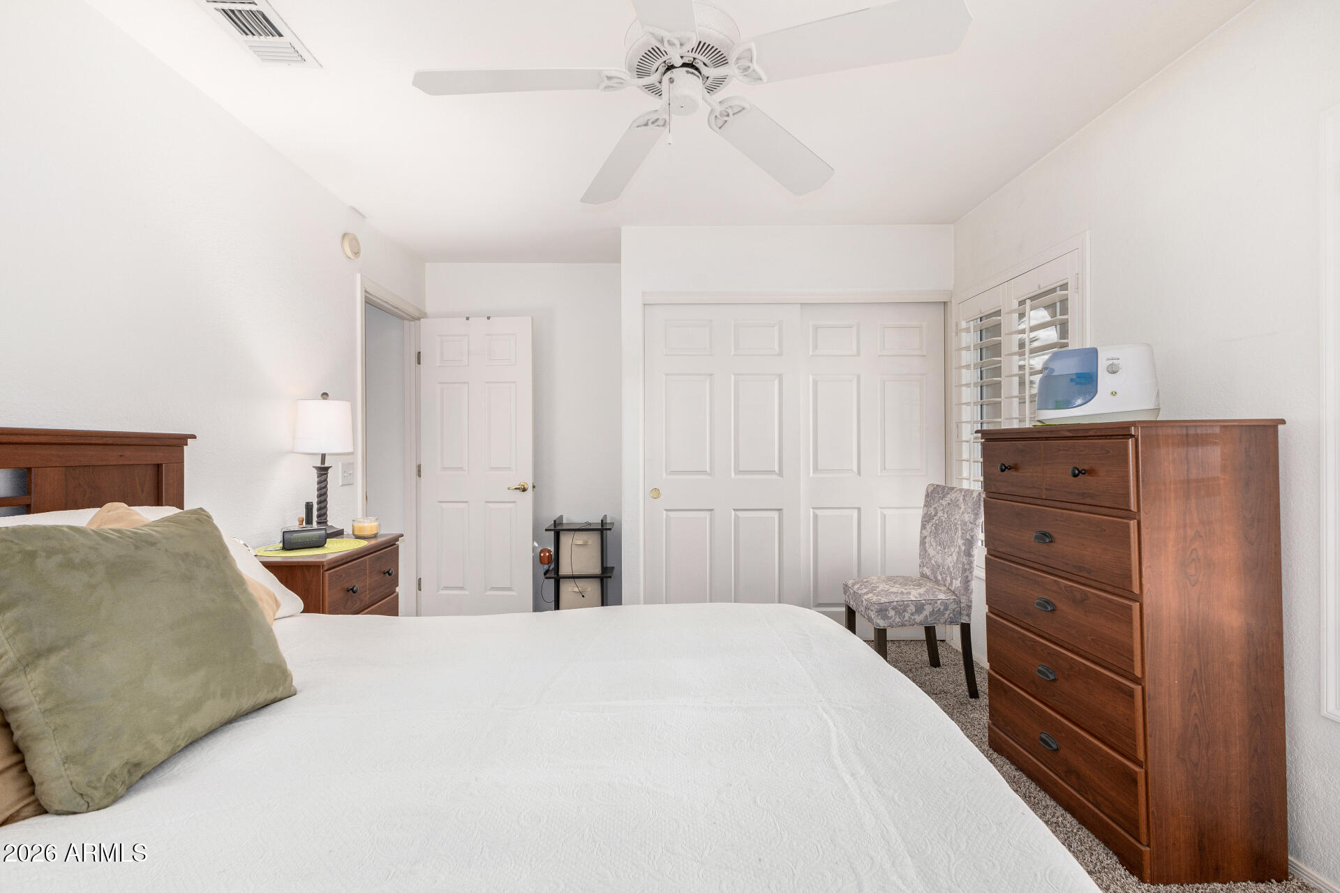 15764 Piccadilly Road Goodyear, AZ 85395 - Photo 22 of 31 a bedroom with a bed and a dresser
