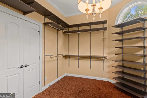 a view of an empty room with a ceiling fan