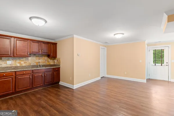 a view of room with wooden floor