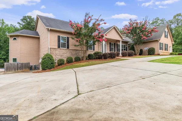 a front view of a house with a yard and garage