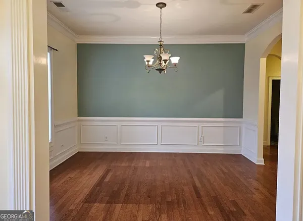 a aerial view of a house next to a big yard