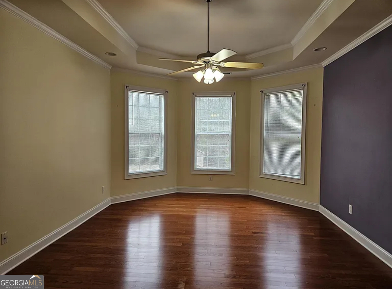 968 Mill Road McDonough, GA 30253 - Photo 56 of 77 a view of an empty room with wooden floor and a window