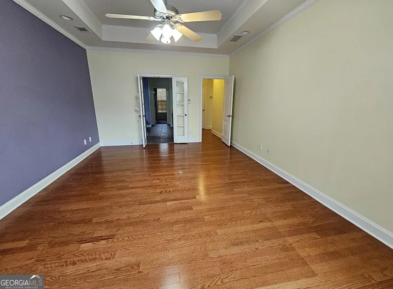 968 Mill Road McDonough, GA 30253 - Photo 57 of 77 a view of an empty room with wooden floor and a ceiling fan