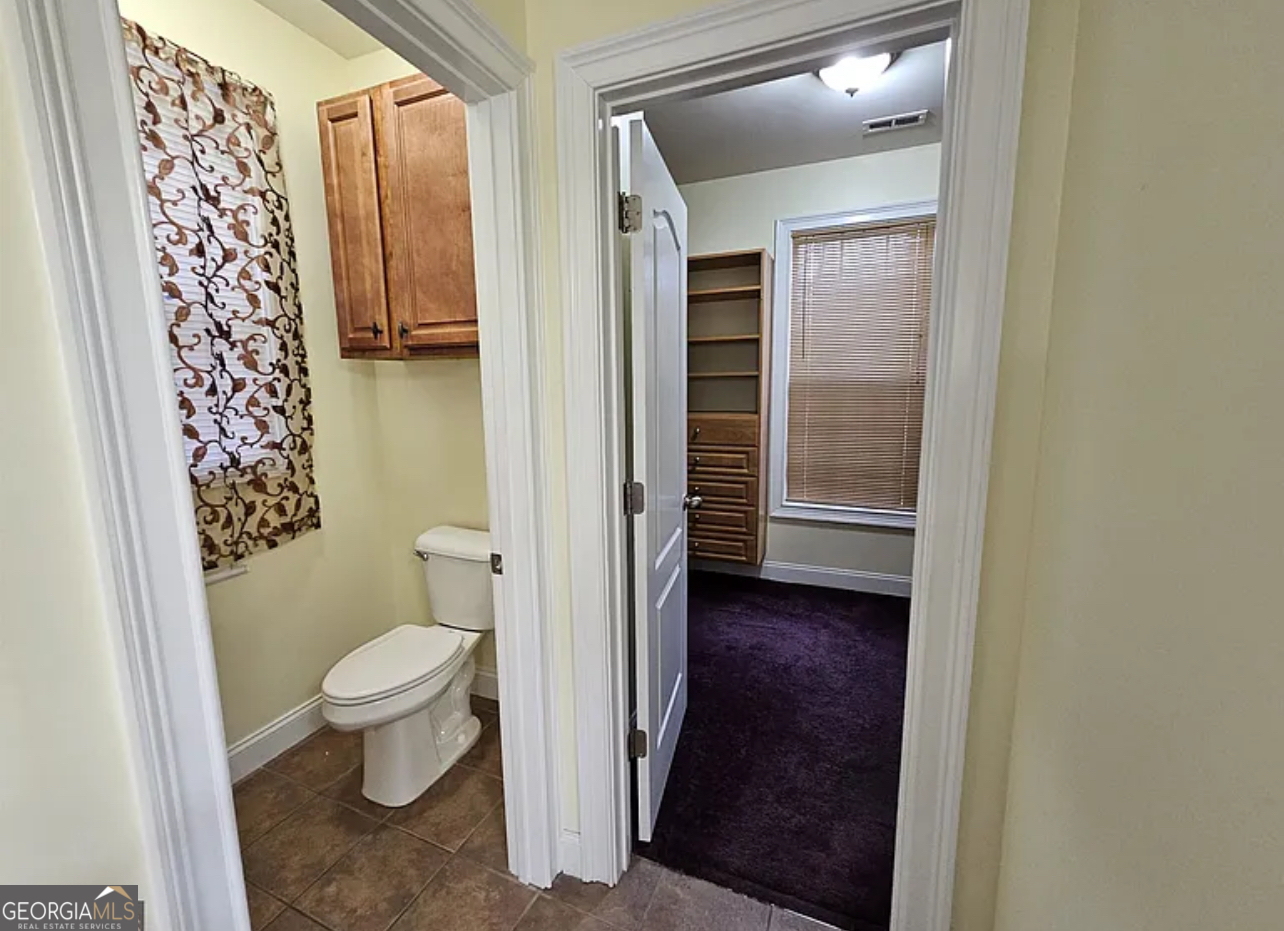 968 Mill Road McDonough, GA 30253 - Photo 60 of 77 a bathroom with a granite countertop toilet and a sink
