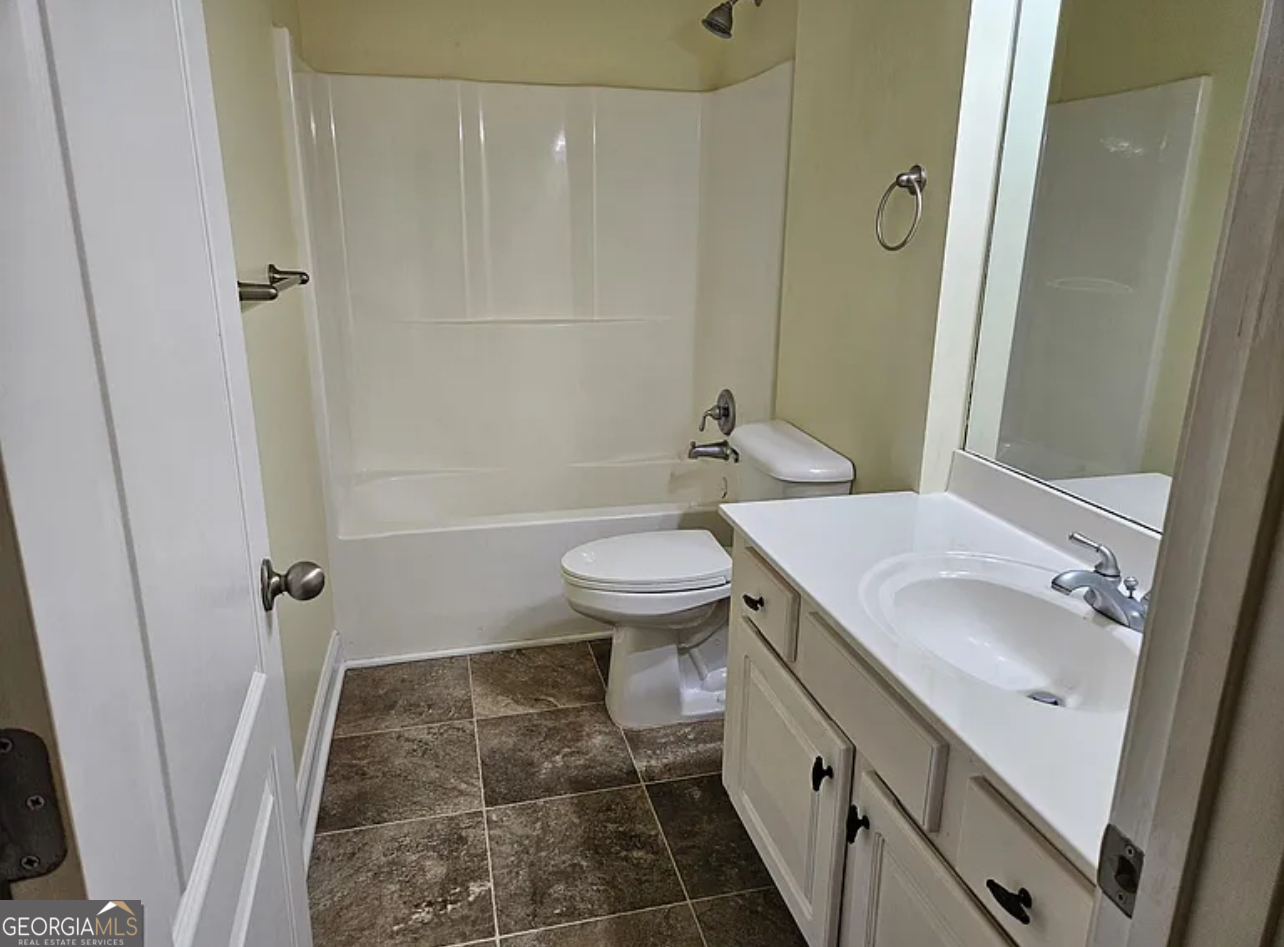 968 Mill Road McDonough, GA 30253 - Photo 65 of 77 a bathroom with a sink a toilet and shower