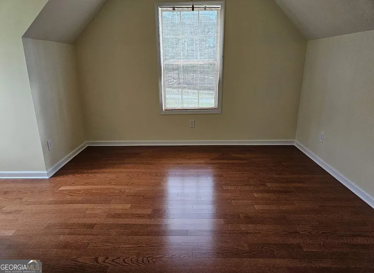 968 Mill Road McDonough, GA 30253 - Photo 67 of 77 a view of an empty room with wooden floor and a window
