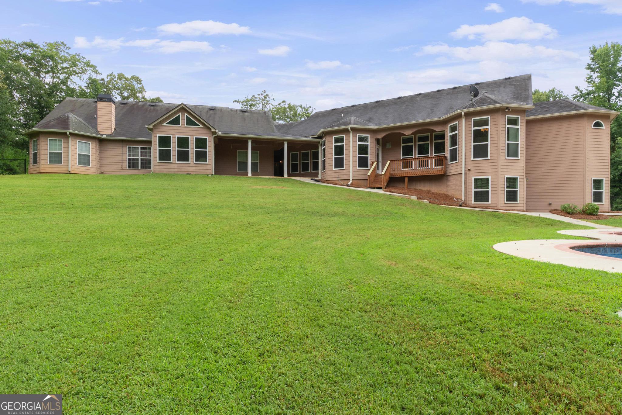 968 Mill Road McDonough, GA 30253 - Photo 73 of 77 a front view of a house with a garden and porch