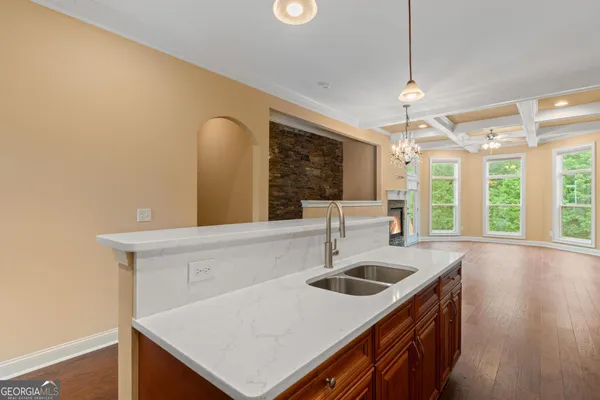 a kitchen with granite countertop stainless steel appliances and white cabinets