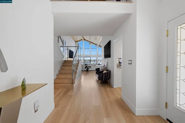 a view of an entryway with wooden floor