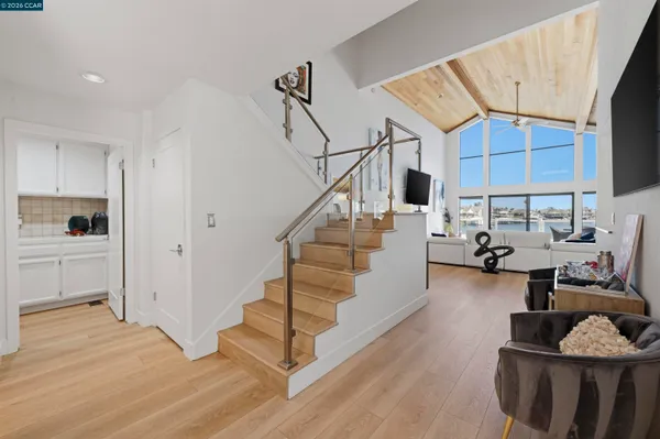 a living room with furniture large flat screen tv and a fireplace