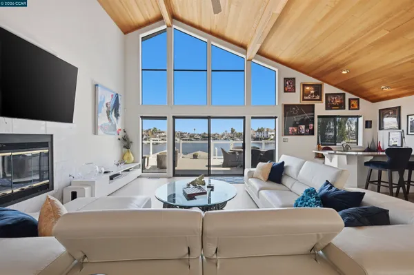 a living room with furniture gym equipment and a large window