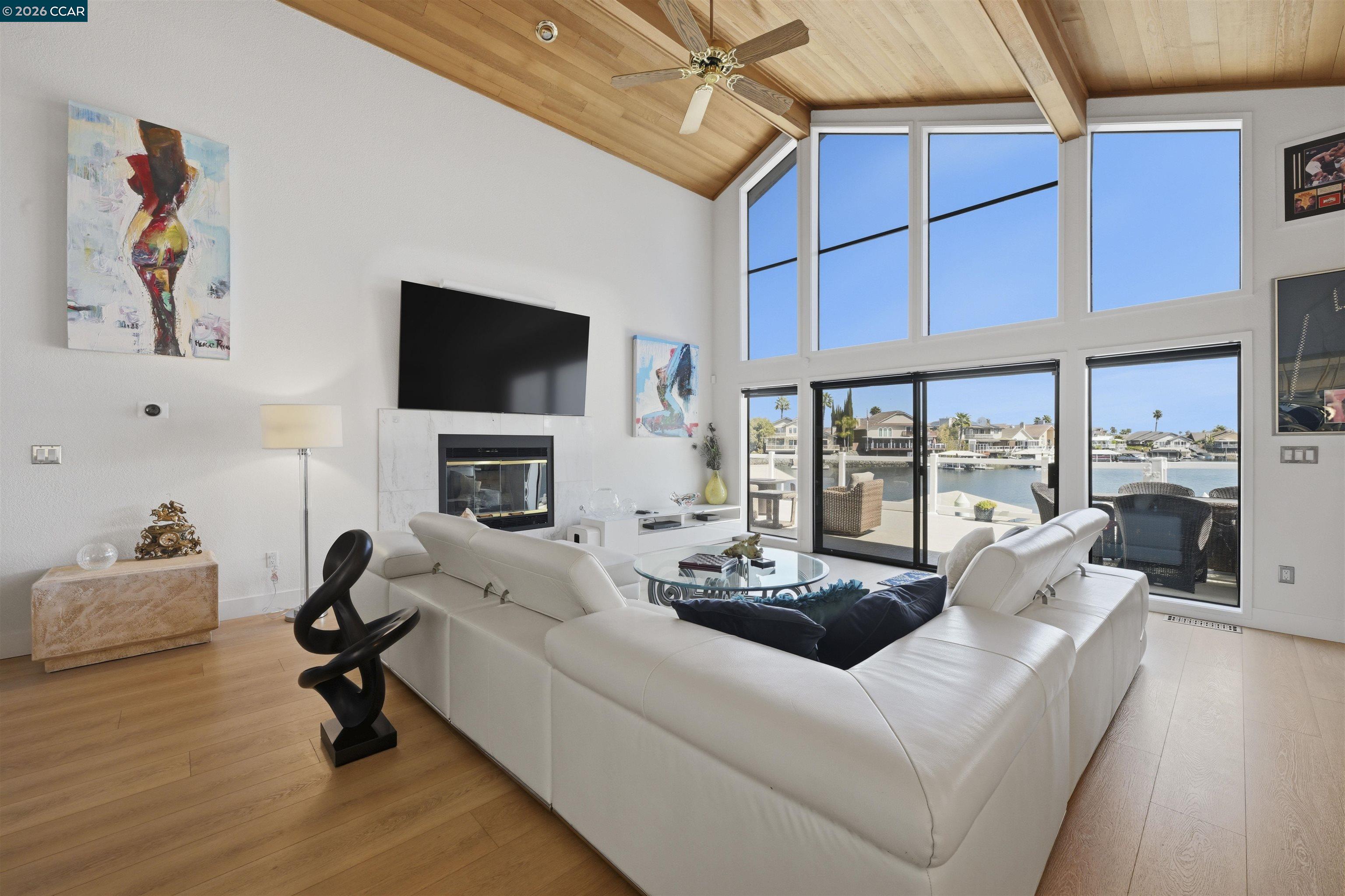 2027 Windward Point Discovery Bay, CA 94505 - Photo 17 of 53 a living room with furniture a fireplace and a flat screen tv
