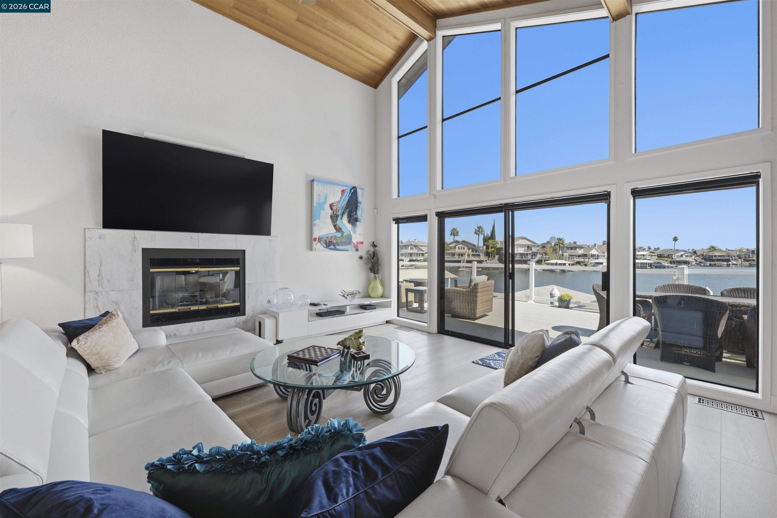 2027 Windward Point Discovery Bay, CA 94505 - Photo 18 of 53 a living room with furniture a fireplace and a flat screen tv