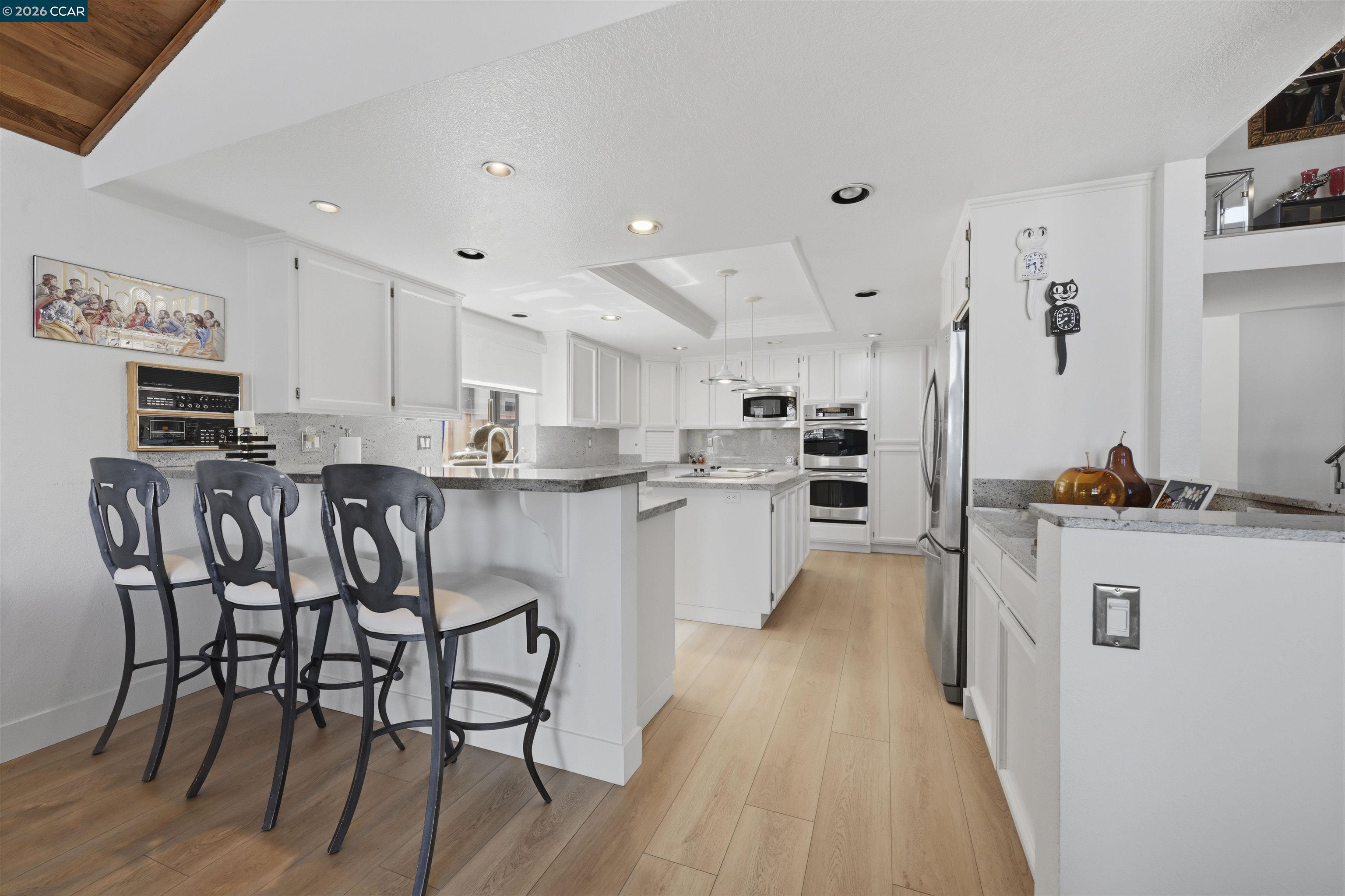 2027 Windward Point Discovery Bay, CA 94505 - Photo 22 of 53 a kitchen with white cabinets and stainless steel appliances