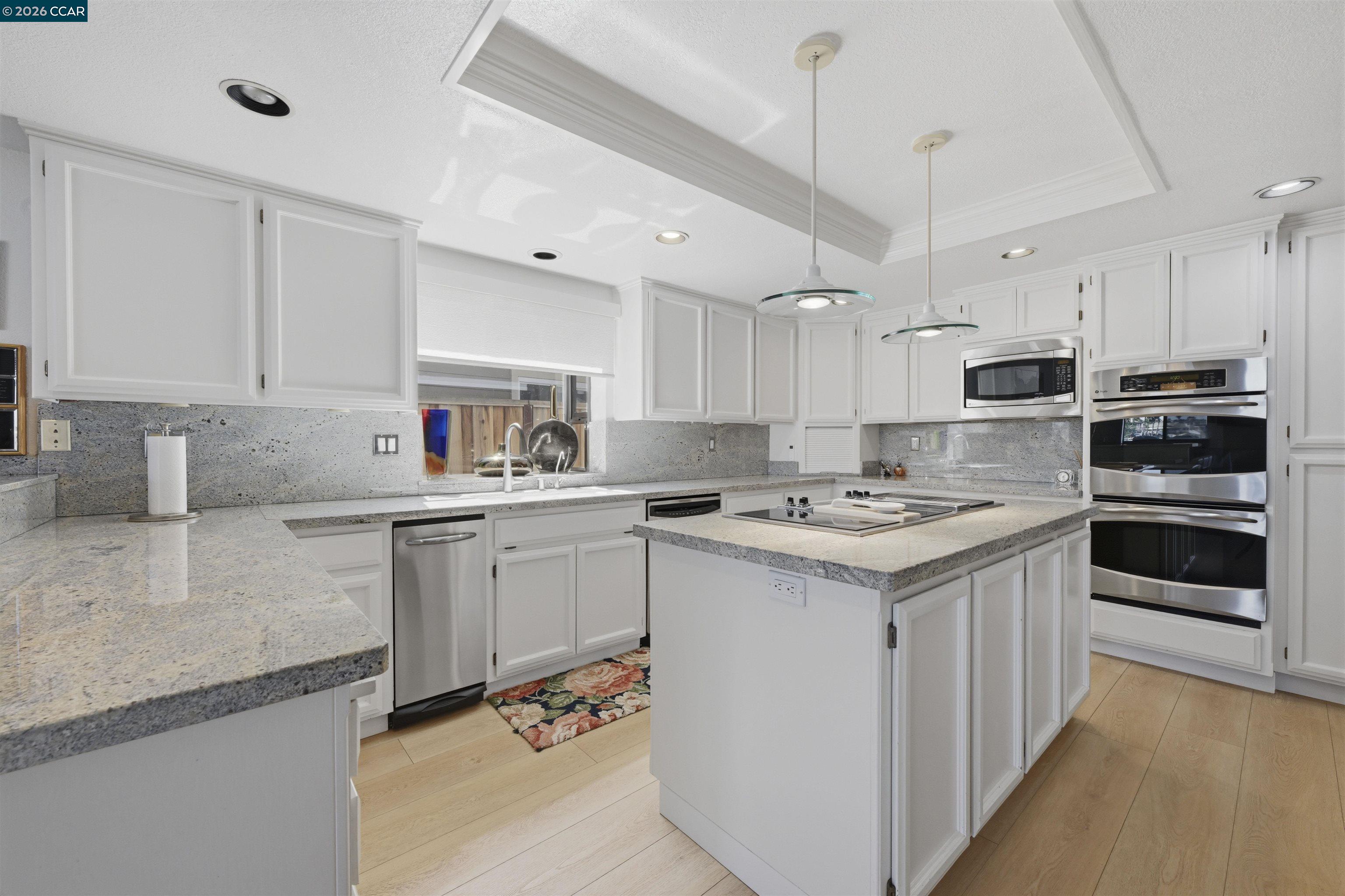 2027 Windward Point Discovery Bay, CA 94505 - Photo 23 of 53 a kitchen with granite countertop a sink stove and cabinets