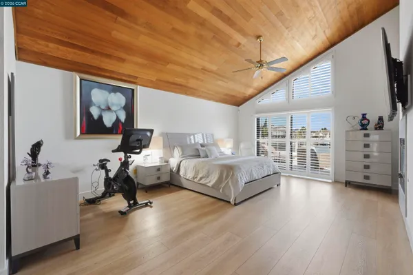 a spacious bedroom with a bed a table and chair