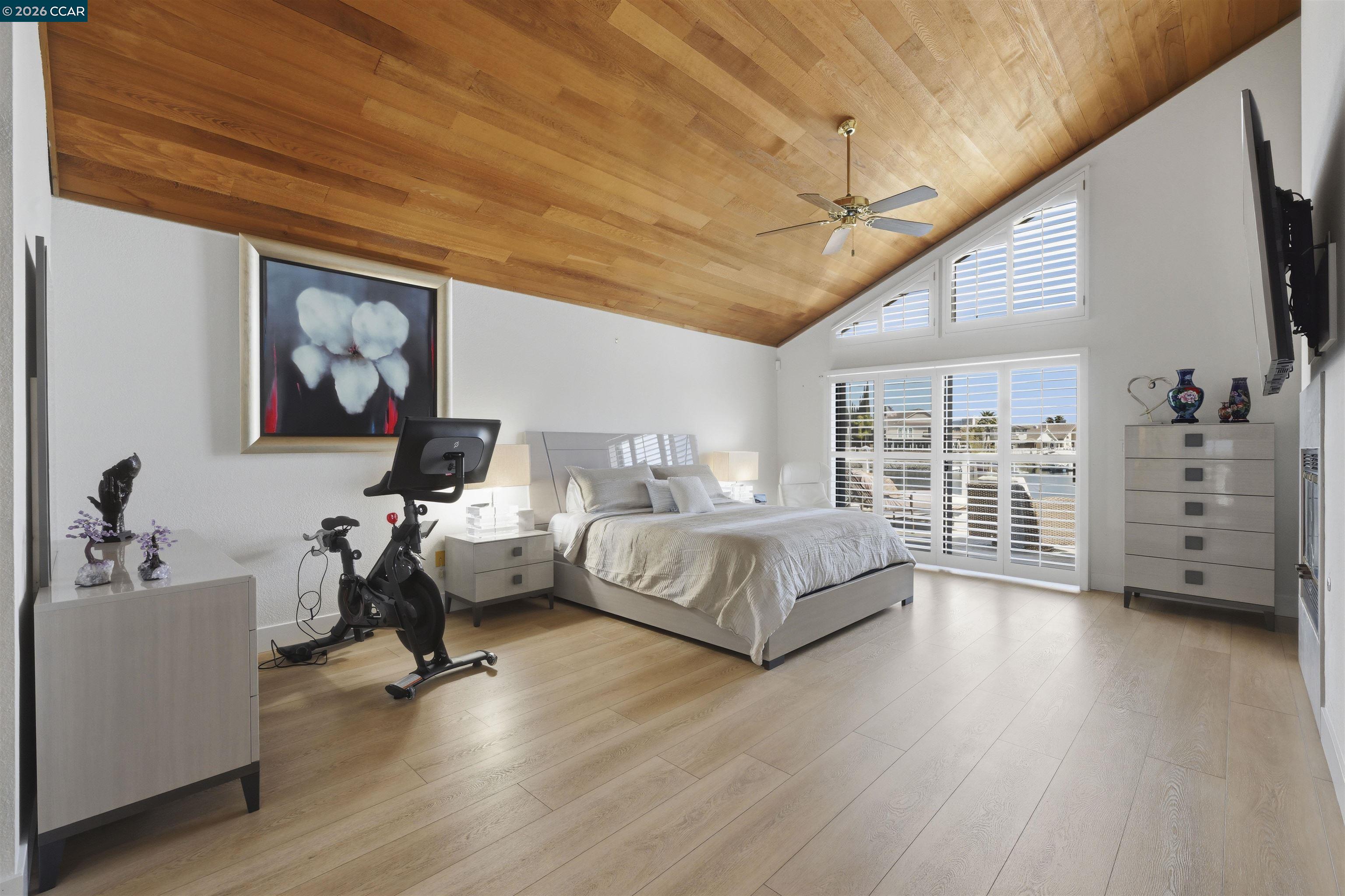 2027 Windward Point Discovery Bay, CA 94505 - Photo 26 of 53 a spacious bedroom with a bed a dresser and wooden floor