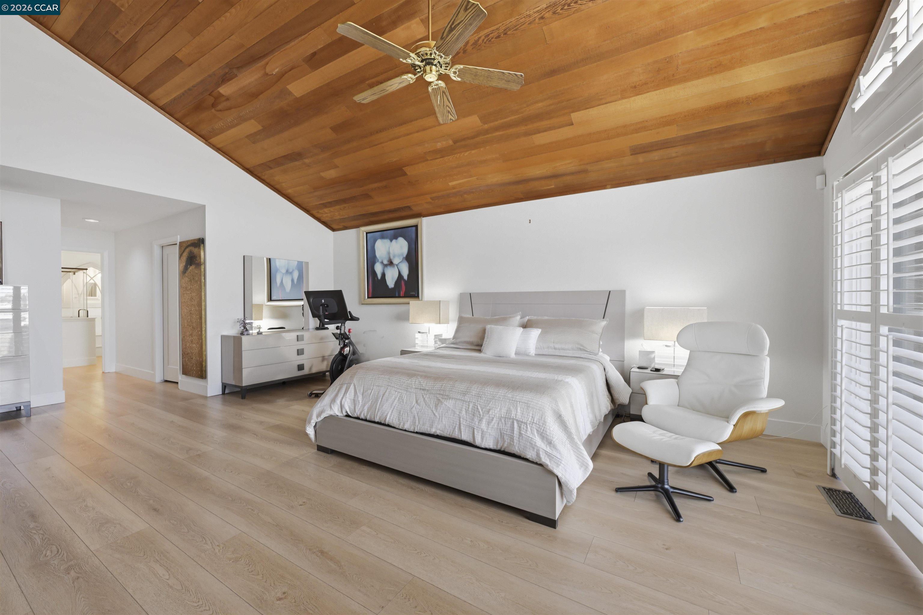 2027 Windward Point Discovery Bay, CA 94505 - Photo 27 of 53 a spacious bedroom with a bed a table and chair