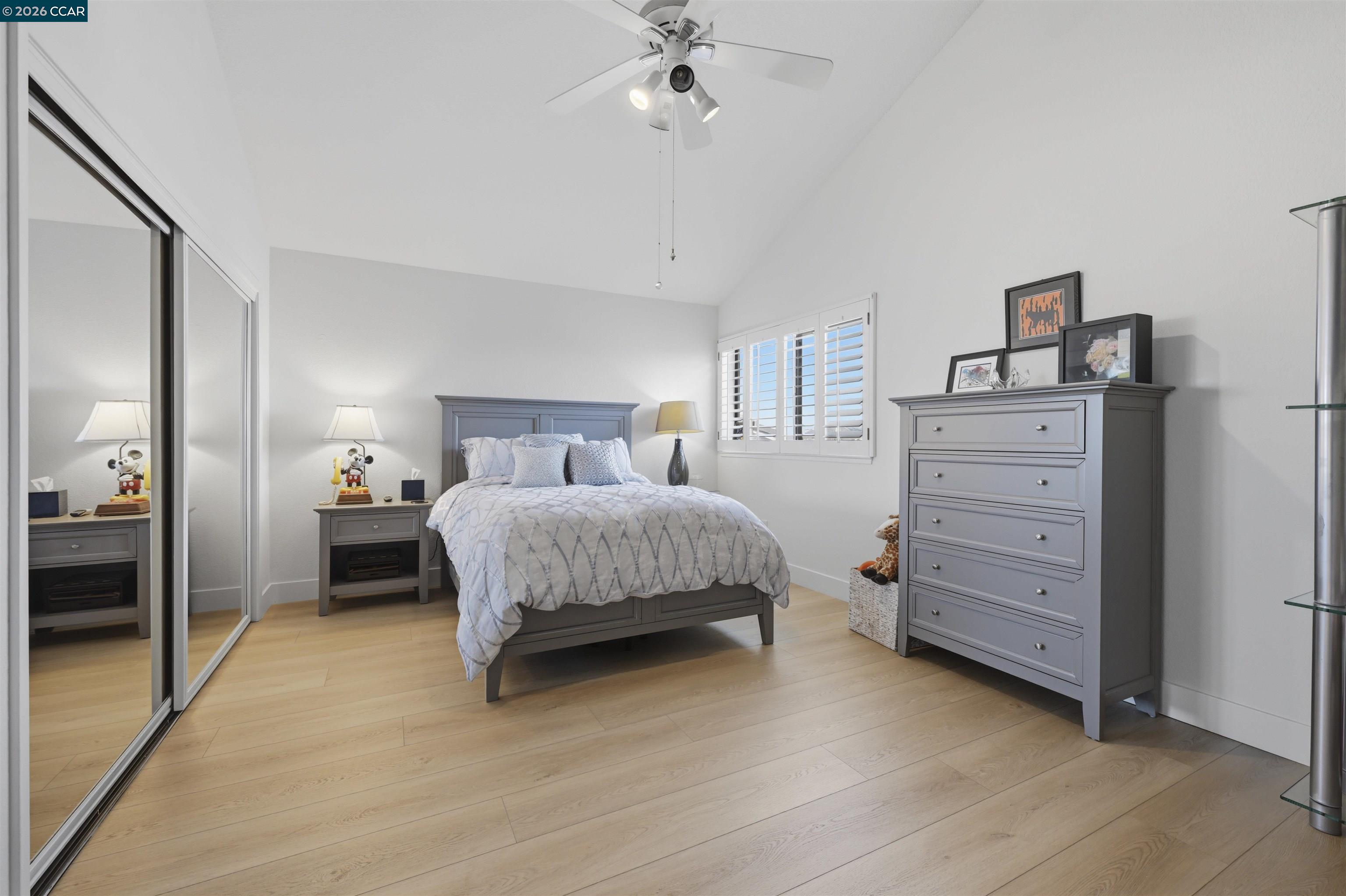 2027 Windward Point Discovery Bay, CA 94505 - Photo 34 of 53 a bedroom with a bed and a chandelier