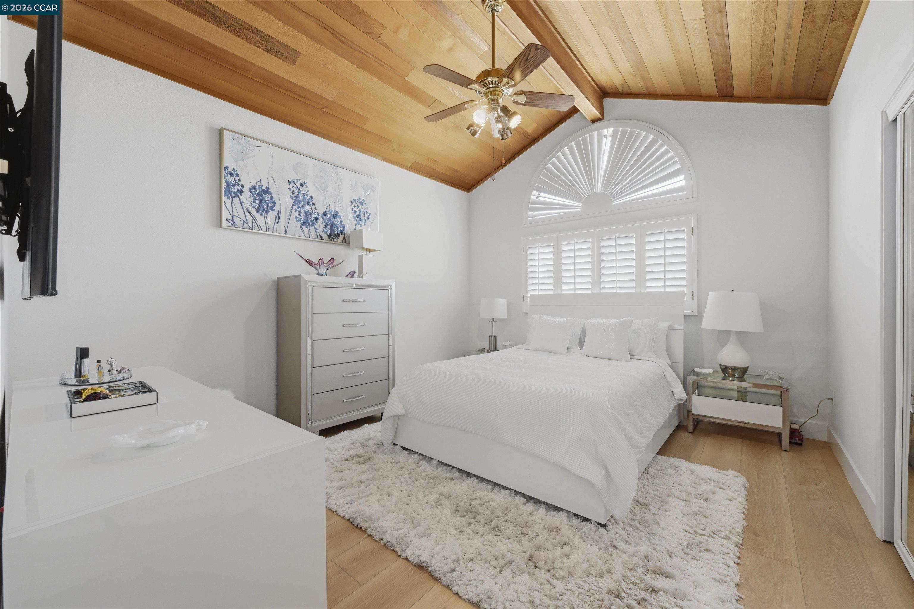 2027 Windward Point Discovery Bay, CA 94505 - Photo 35 of 53 a bedroom with a bed and a chandelier