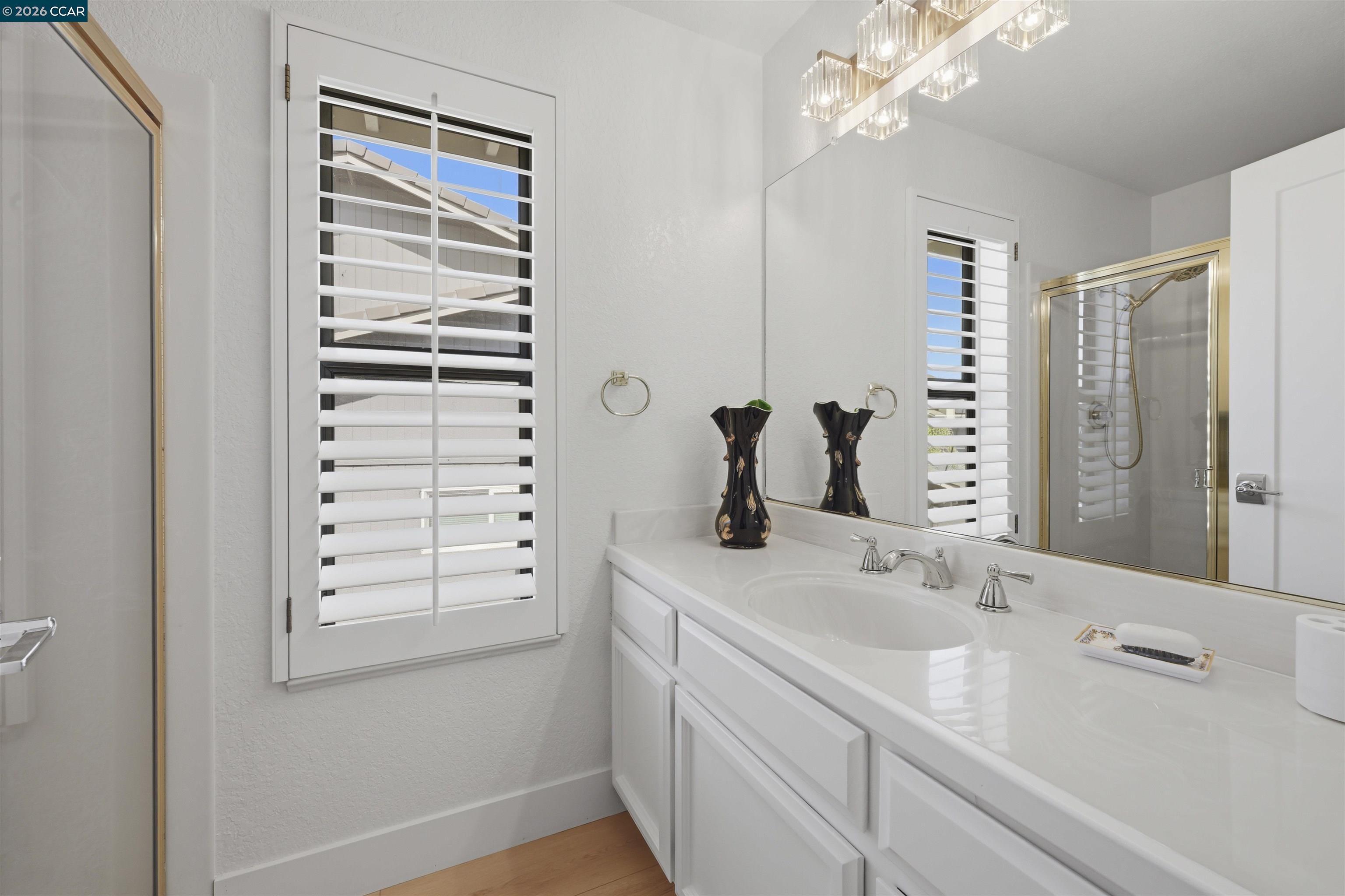 2027 Windward Point Discovery Bay, CA 94505 - Photo 37 of 53 a bathroom with a double vanity sink a vanity and a mirror