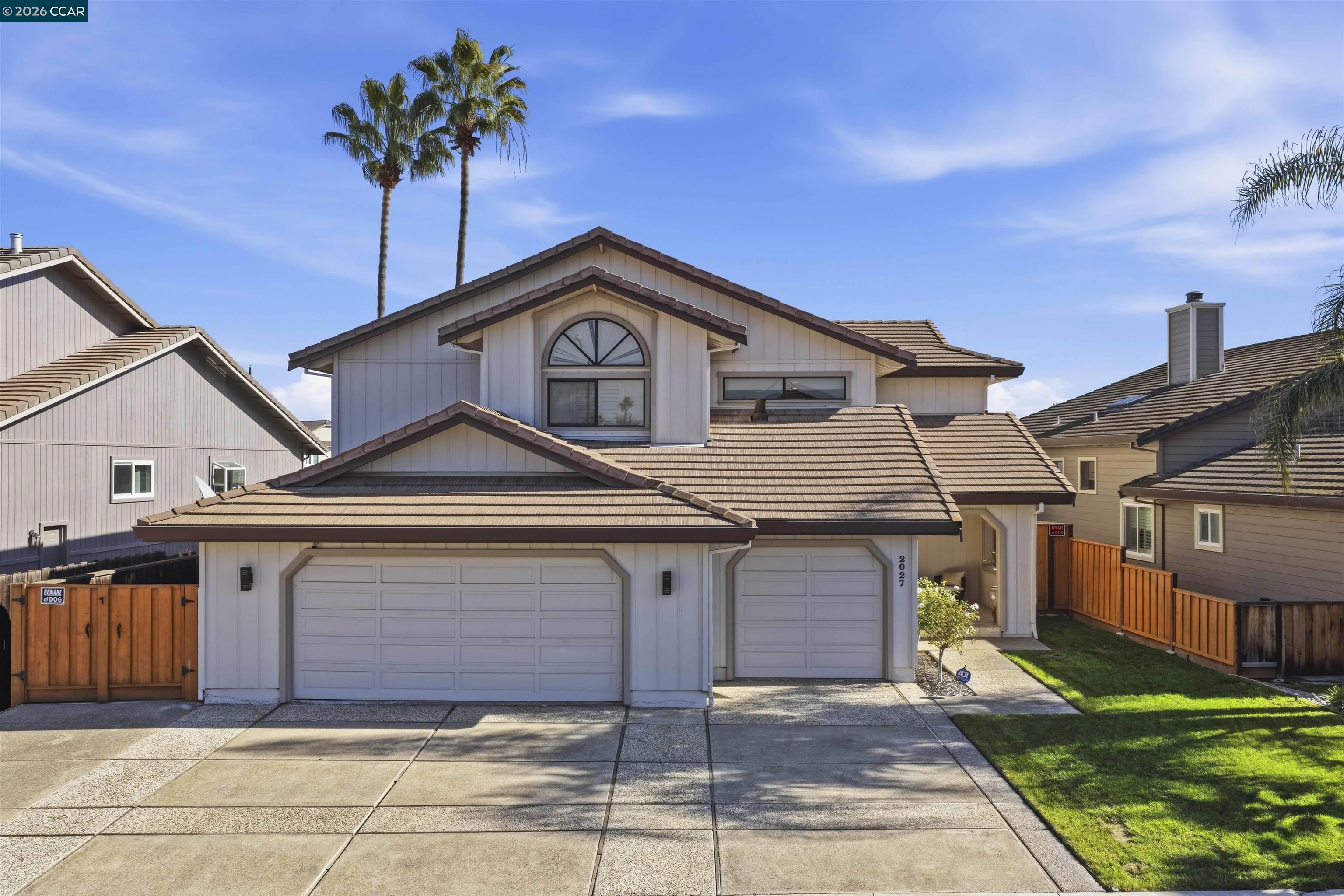 2027 Windward Point Discovery Bay, CA 94505 - Photo 50 of 53 a front view of a house with a yard and garage