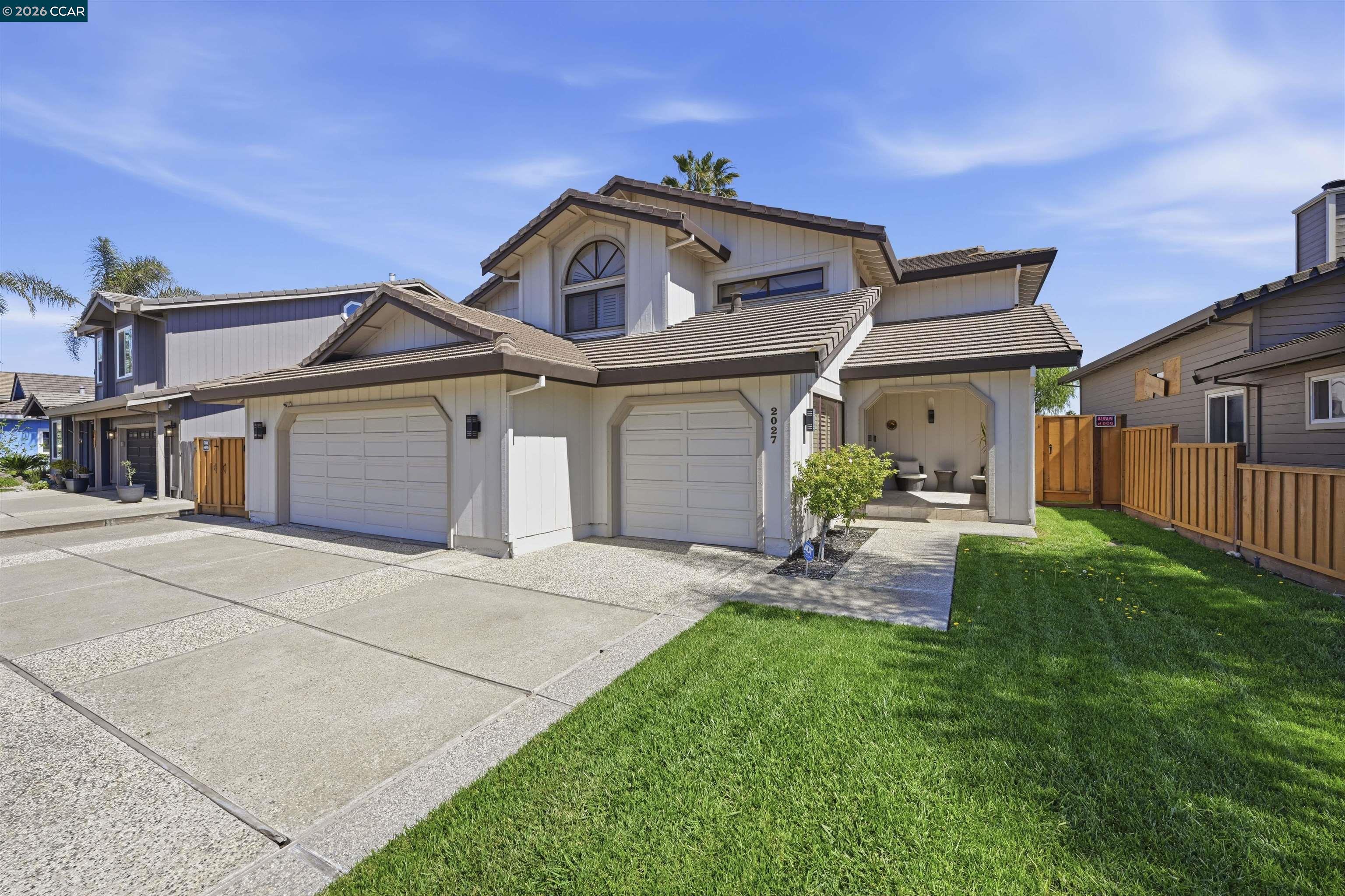 2027 Windward Point Discovery Bay, CA 94505 - Photo 51 of 53 a front view of a house with a yard and garage