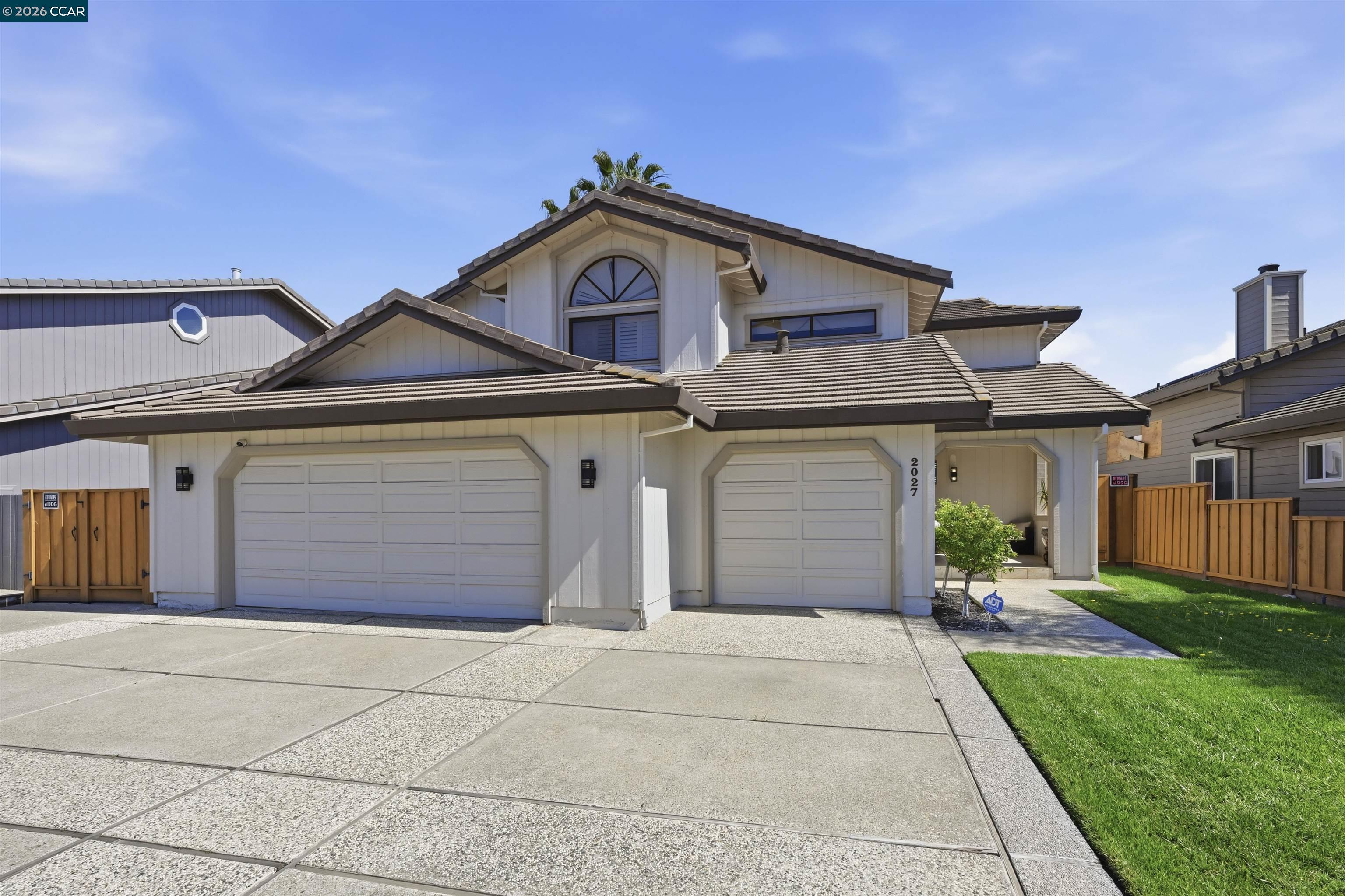 2027 Windward Point Discovery Bay, CA 94505 - Photo 52 of 53 a front view of a house with a yard and garage