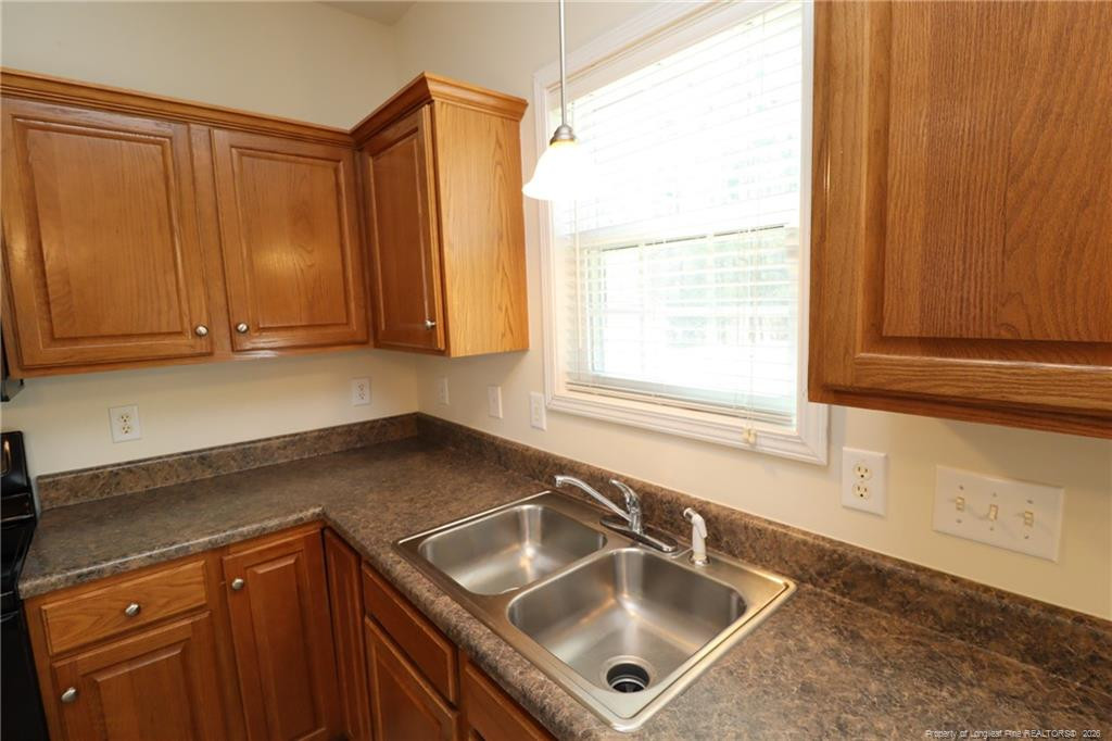 2936 Filbert Street Raleigh, NC 27610 - Photo 11 of 27 a kitchen with stainless steel appliances granite countertop a sink window and cabinets